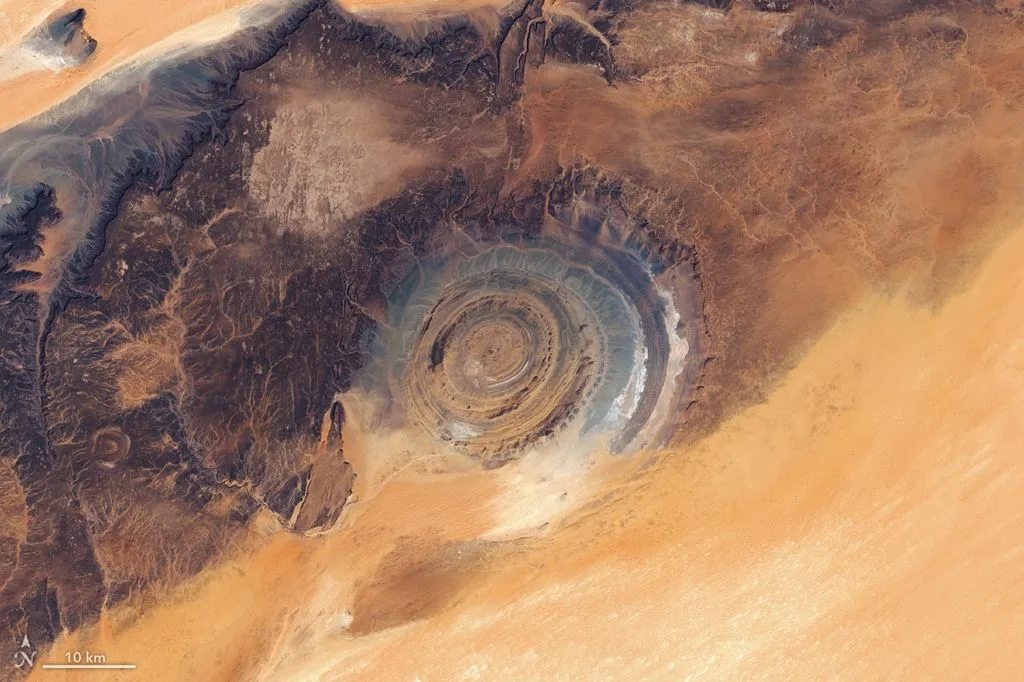 The Richat Structure appears as a giant "bull's eye" on a plateau in Mauritania in this mosaic, composed of images captured by the OLI (Operational Land Imager) on Landsat 9 and Landsat 8 on March 5 and March 6, 2026, respectively. NASA Earth Observatory/Lauren Dauphin