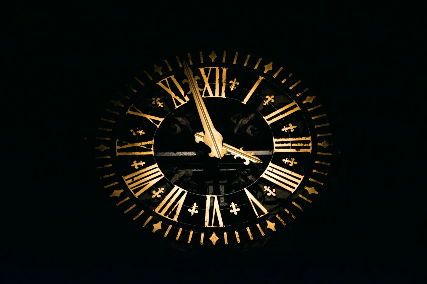 Fig. 1 — An antique tower clock illuminated in the dark — every clock, no matter how old or new, carries an unfixable quantum error