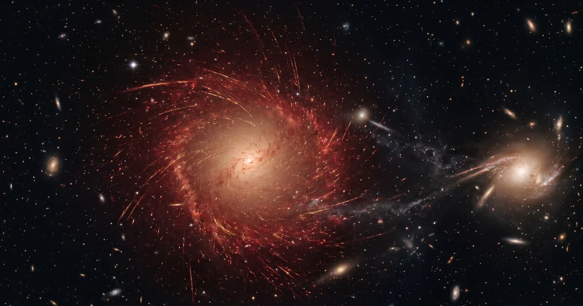 An artist's rendering of galaxy XMM-VID1-2075 as it appeared less than 2 billion years after the Big Bang. Unlike a typical young galaxy, its stars move in random directions rather than rotating as a cohesive disc — a state astronomers call a slow rotator. A bright mass visible to the side suggests an ongoing interaction with another object. Credit: AI/ScienceDaily.com.