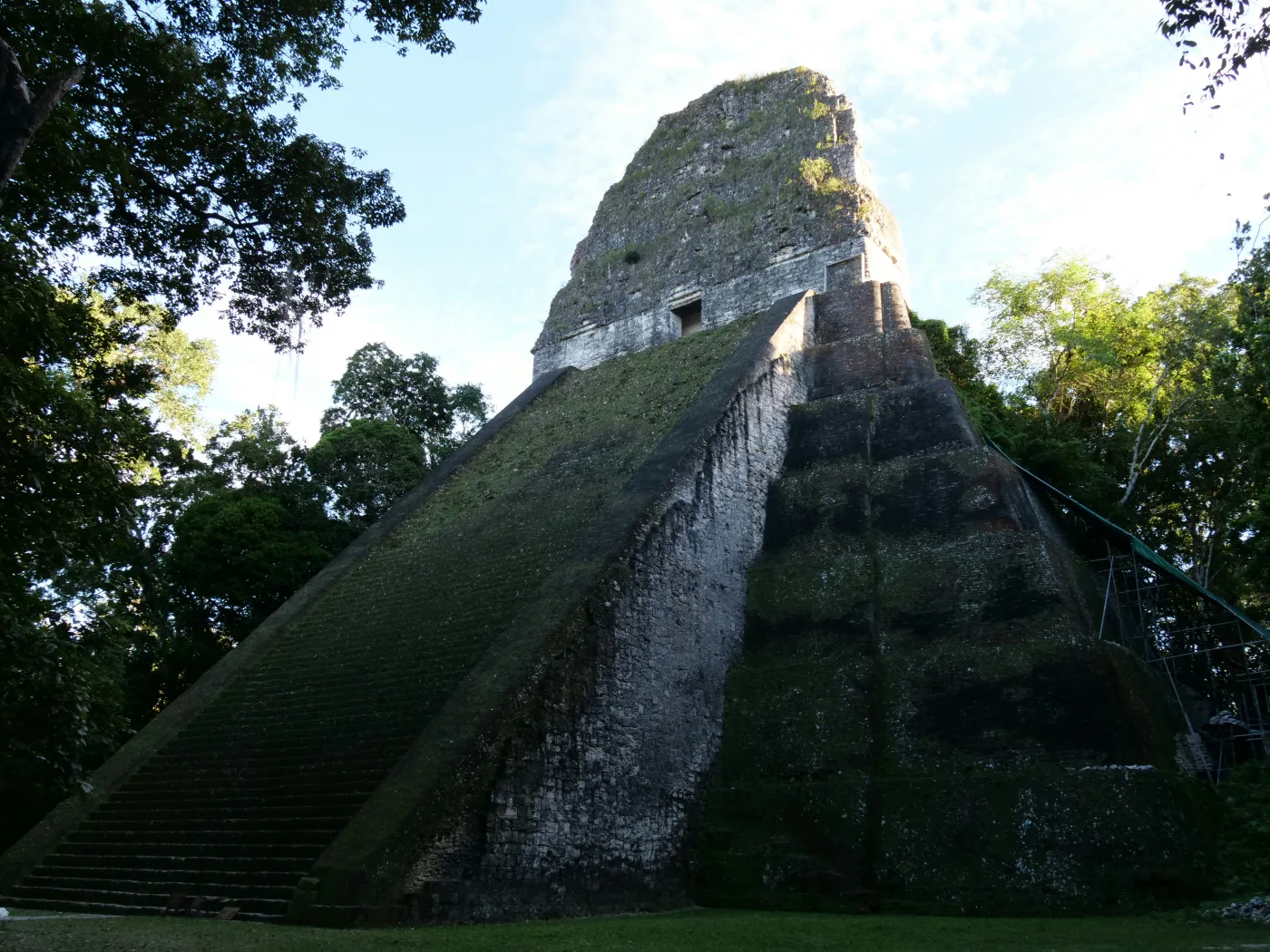 A steep stone pyramid temple rises above the forest, the kind of monumental building that marked Mesoamerica's early cities. Researchers say it was not grand temples alone, but how power and labour were shared, that decided which cities endured. Image: Unsplash.