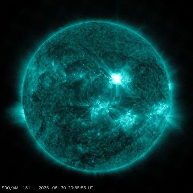 The Sun in extreme ultraviolet light, colorized teal to highlight extremely hot material. The bright white flash in the upper right is the X1.1 solar flare, which peaked at 4:50 p.m. ET. Image: NASA/SDO.